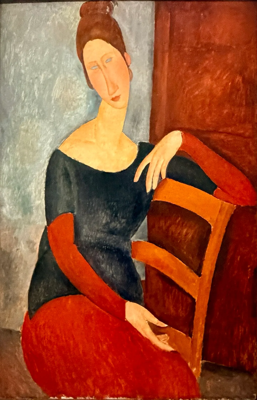Jeanne seated with the arm resting on the back of the chair