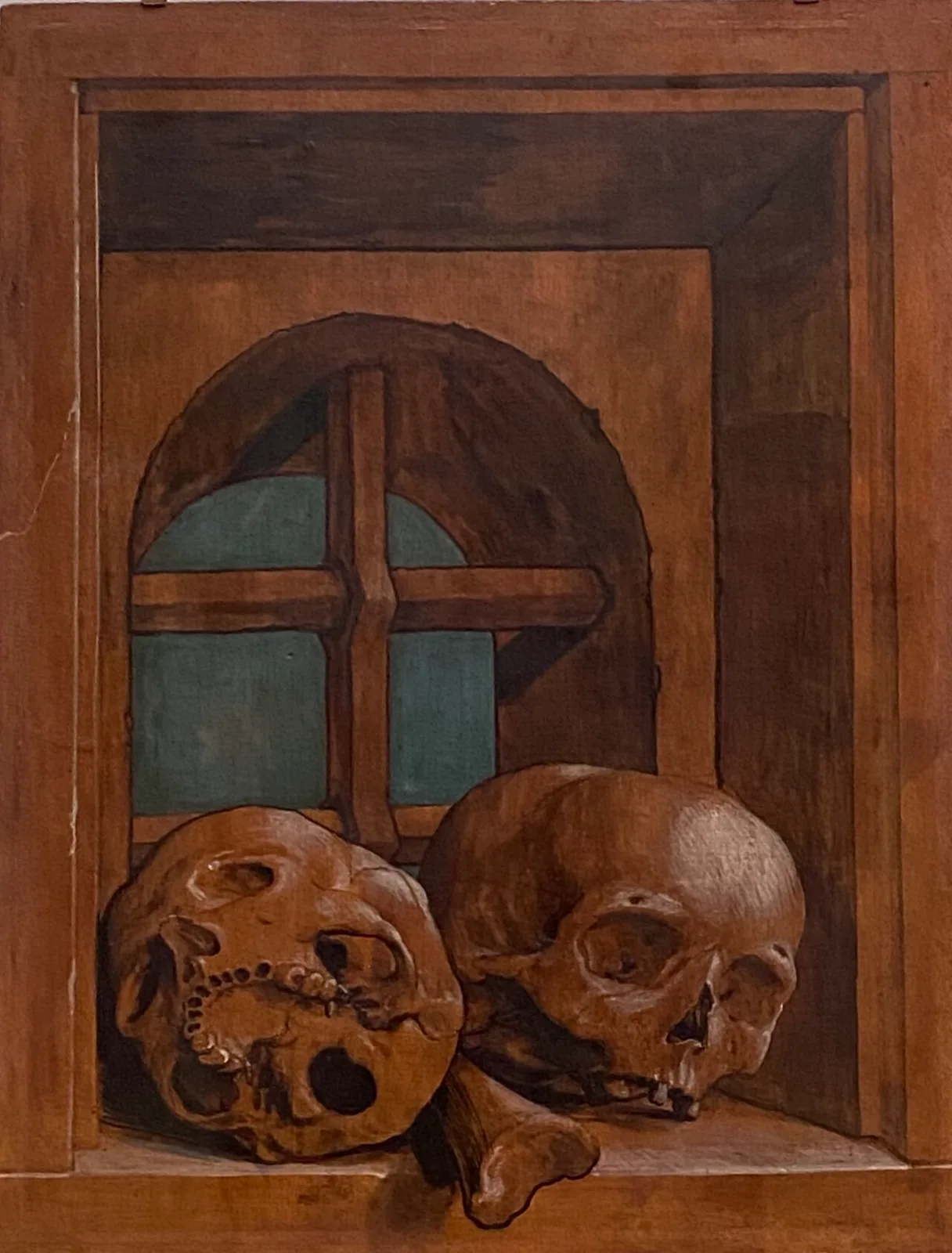 Two skulls in a window niche