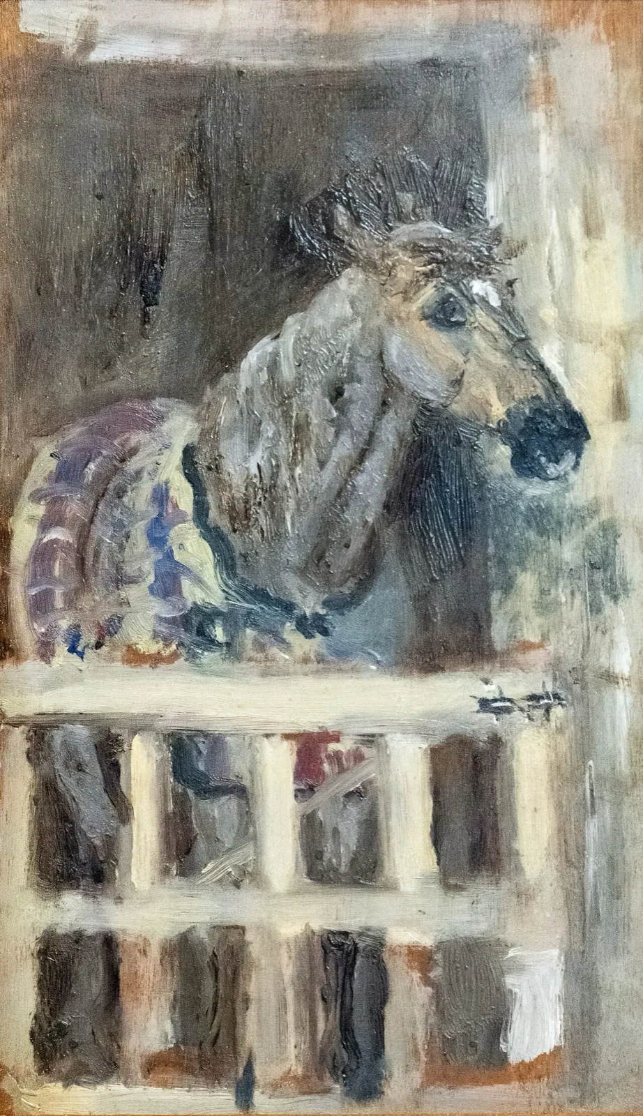 Horse behind a gate in a stall