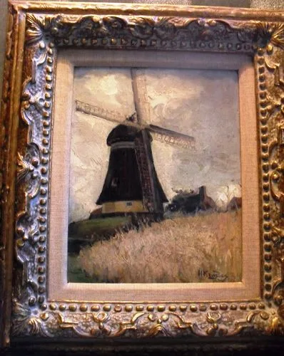 Man in a mill in a landscape with a cornfield