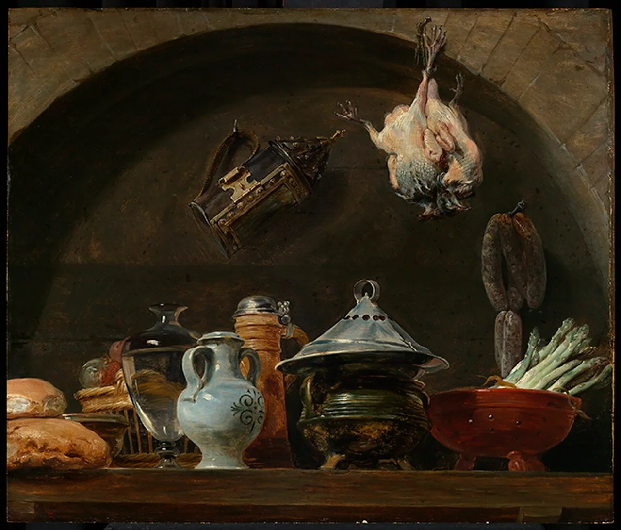 A still life with various pottery, bread, a lamp and plucked poultry in a niche