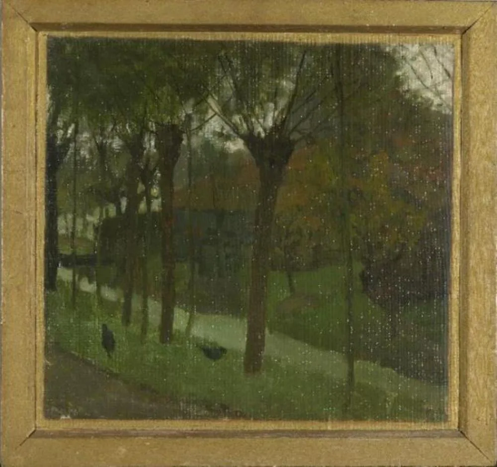 Willows bordering an irrigation ditch near a farm building