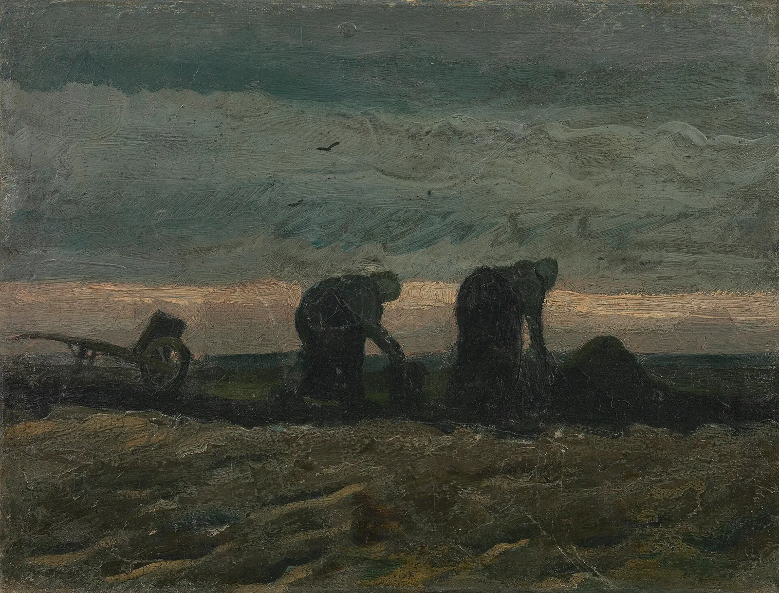 Two women digging, and a wheelbarrow