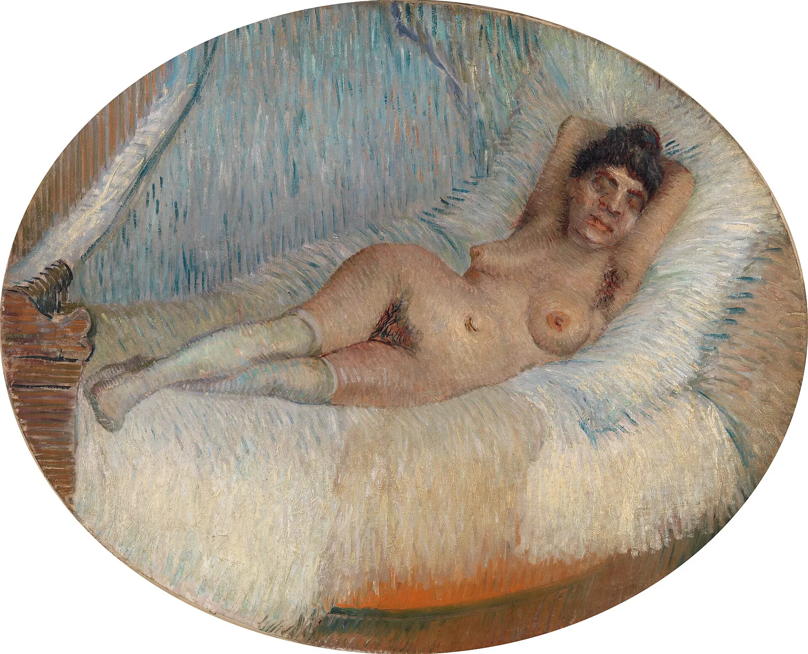 Nude woman on a bed
